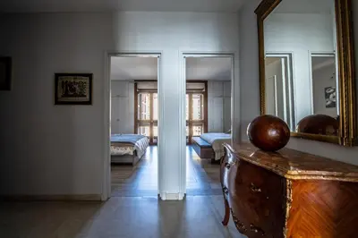 a living room with a mirror and a dresser at Appartement Front de Mer Hyper Centre in Ajaccio