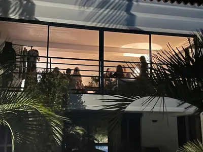 a group of people standing on a balcony watching the sunset at Villa Macalia in Pietrosella