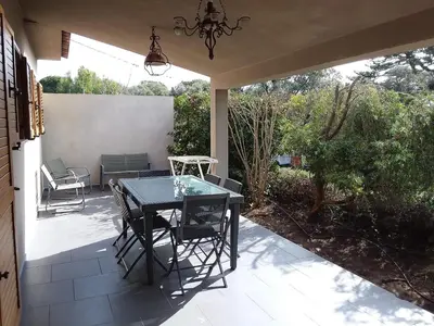 a patio with a table and chairs on it at casa-lesia in Porto-Vecchio