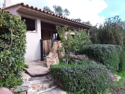 a house with a gate and a stone path leading to it at casa-lesia in Porto-Vecchio