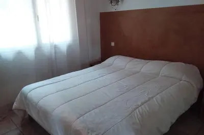 a white bed in a bedroom with a window at casa-anghjulina in Porto-Vecchio
