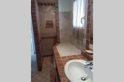 a bathroom with a sink and a shower at casa-anghjulina in Porto-Vecchio