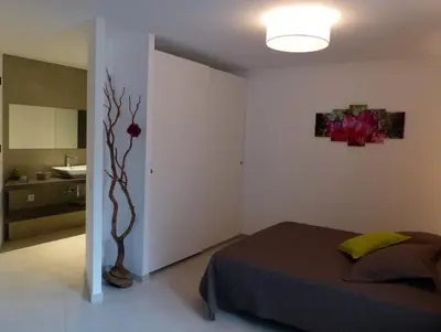 a bedroom with a bed and a flower on the wall at Villa Laricio in Bonifacio