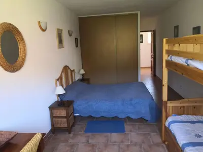 a bedroom with two beds and a bunk bed at l'Ogliastru in Ucciani