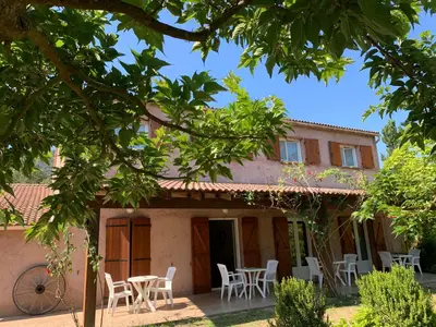 an external view of a house with chairs and tables at l'Ogliastru in Ucciani