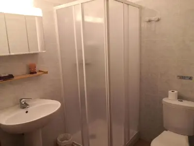 a bathroom with a shower and a toilet and a sink at l'Ogliastru in Ucciani