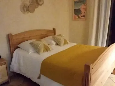 a bedroom with a bed with yellow sheets and pillows at Magnifique villa piscine Propriano in Olmeto