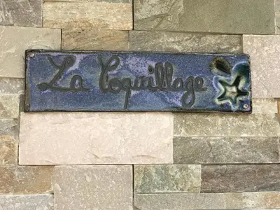 a sign that says la leeuvillage on a brick wall at Fiore di Machja in Coti-Chiavari