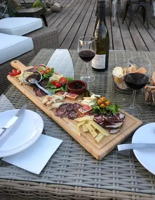 a table with a plate of food and wine glasses at Fiore di Machja in Coti-Chiavari