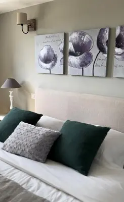 a bedroom with a bed with four pictures on the wall at Fiore di Machja in Coti-Chiavari