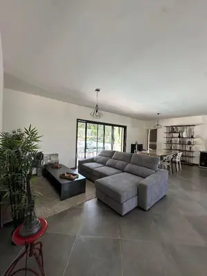 a living room with a couch and a table at VILLA BENOA in Oletta