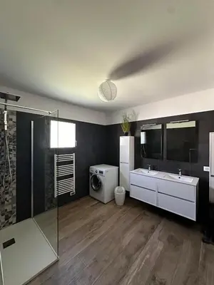 a bathroom with a shower and a toilet and a sink at VILLA BENOA in Oletta