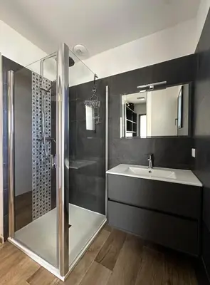 a bathroom with a sink and a shower at VILLA BENOA in Oletta