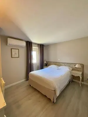 a bedroom with a large white bed and a window at Franceschini in Ghisonaccia