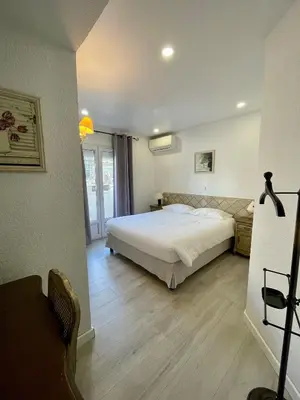 a bedroom with a large bed in a room at Franceschini in Ghisonaccia