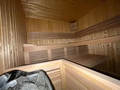 a sauna with wooden walls and floors and a tub at Franceschini in Ghisonaccia