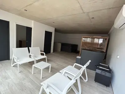 a room with white chairs and a table and a room at Franceschini in Ghisonaccia