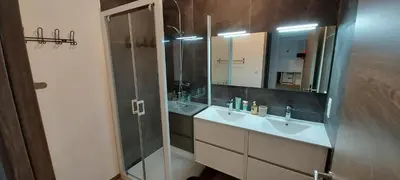 a bathroom with two sinks and a glass shower at Corse et Zen LOFT ZEN 145m2 8à9 pers in Taglio-Isolaccio