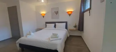 a bedroom with a large bed with two towels on it at Corse et Zen LOFT ZEN 145m2 8à9 pers in Taglio-Isolaccio