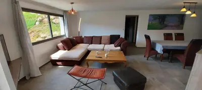 a living room with a couch and a table at Corse et Zen LOFT ZEN 145m2 8à9 pers in Taglio-Isolaccio