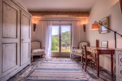 a room with a desk and a door with a window at Villa Serenita Pallombaggia in Porto-Vecchio