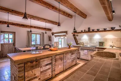 a kitchen with wooden counters and a large center island at Villa Serenita Pallombaggia in Porto-Vecchio