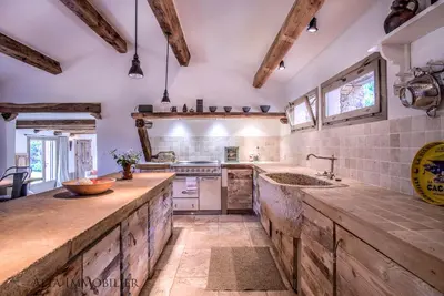 a large kitchen with wooden counter tops and wooden beams at Villa Serenita Pallombaggia in Porto-Vecchio