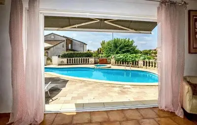 a view of a swimming pool through a window at Villa ensoleillée & Piscine privée à Aléria in Aléria