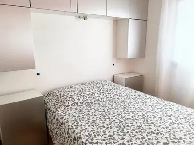 a bedroom with a bed with a black and white blanket at Villa ensoleillée & Piscine privée à Aléria in Aléria