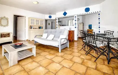 a living room with a couch and a table at Villa ensoleillée & Piscine privée à Aléria in Aléria
