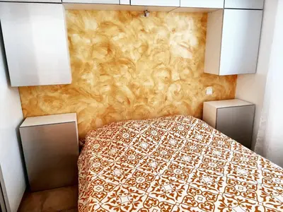 a bedroom with a bed and a wall at Villa ensoleillée & Piscine privée à Aléria in Aléria