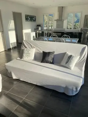 a large white bed in a room with a kitchen at Matteo Laricio in Peri
