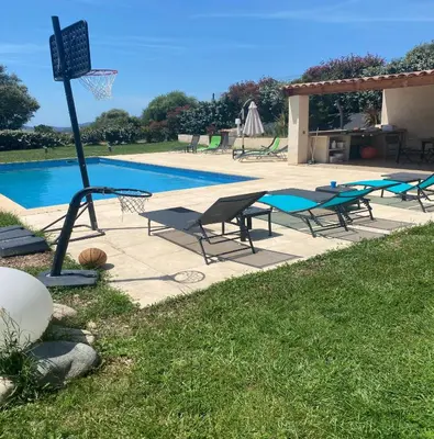 a basketball hoop and picnic tables next to a pool at Matteo Laricio in Peri