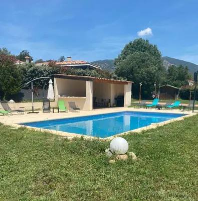 a house with a swimming pool in the grass at Matteo Laricio in Peri