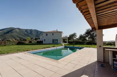 a backyard with a swimming pool and a house at Matteo Laricio in Peri