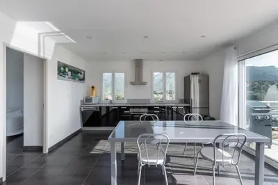 a kitchen with a table and chairs in a room at Matteo Laricio in Peri