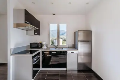 a kitchen with a stainless steel refrigerator and a sink at Matteo Leccia in Peri