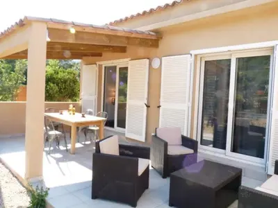 a patio with a table and chairs and a table and a table and chairs at VILLAS MATTEU in Galeria