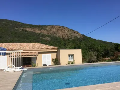 a house with a swimming pool in front of a mountain at VILLAS MATTEU in Galeria