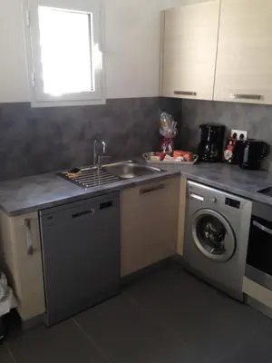 a kitchen with a sink and a washing machine at VILLAS MATTEU in Galeria
