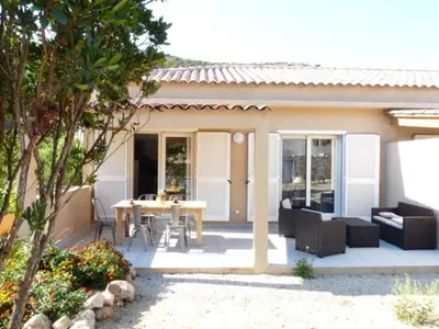 a patio with a table and chairs in front of a house at VILLAS MATTEU in Galeria