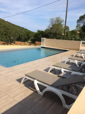 a group of lounge chairs next to a swimming pool at VILLAS MATTEU in Galeria