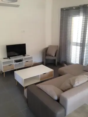 a living room with a couch and a tv at VILLAS MATTEU in Galeria