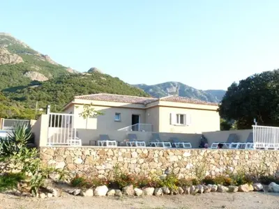 a house with a stone wall in front of a house at VILLAS MATTEU in Galeria