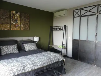 a bedroom with a bed and a green wall at Casa Peppina - Chez Tonio et Sylvie in Sari Solenzara