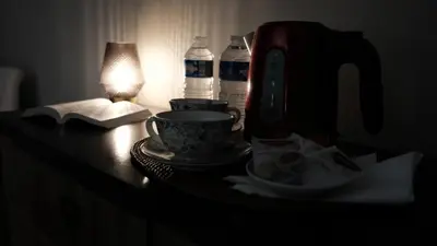a table with a coffee maker and a cup on it at Casa Peppina - Chez Tonio et Sylvie in Sari Solenzara