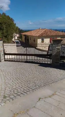 a black metal fence in front of a house at Casa Peppina - Chez Tonio et Sylvie in Sari Solenzara