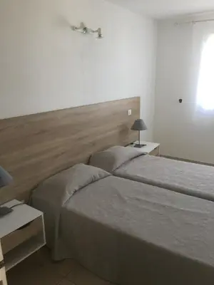 a bedroom with two beds and a headboard at Appart'Hôtel A Punta in Galeria