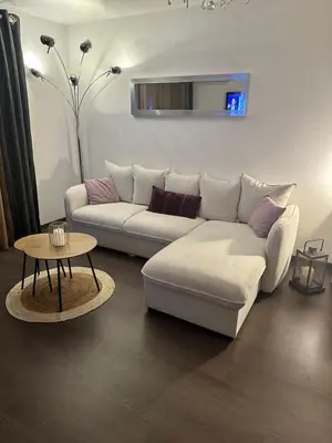 a living room with a white couch and a table at Joli T2 récent 'Le VIVALDI' in Ajaccio