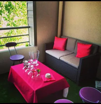 a room with a table and a couch and a pink table sidx sidx at Joli T2 récent 'Le VIVALDI' in Ajaccio